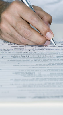 Man Filling out Tax Form