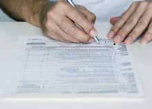 Man Filling out Tax Form
